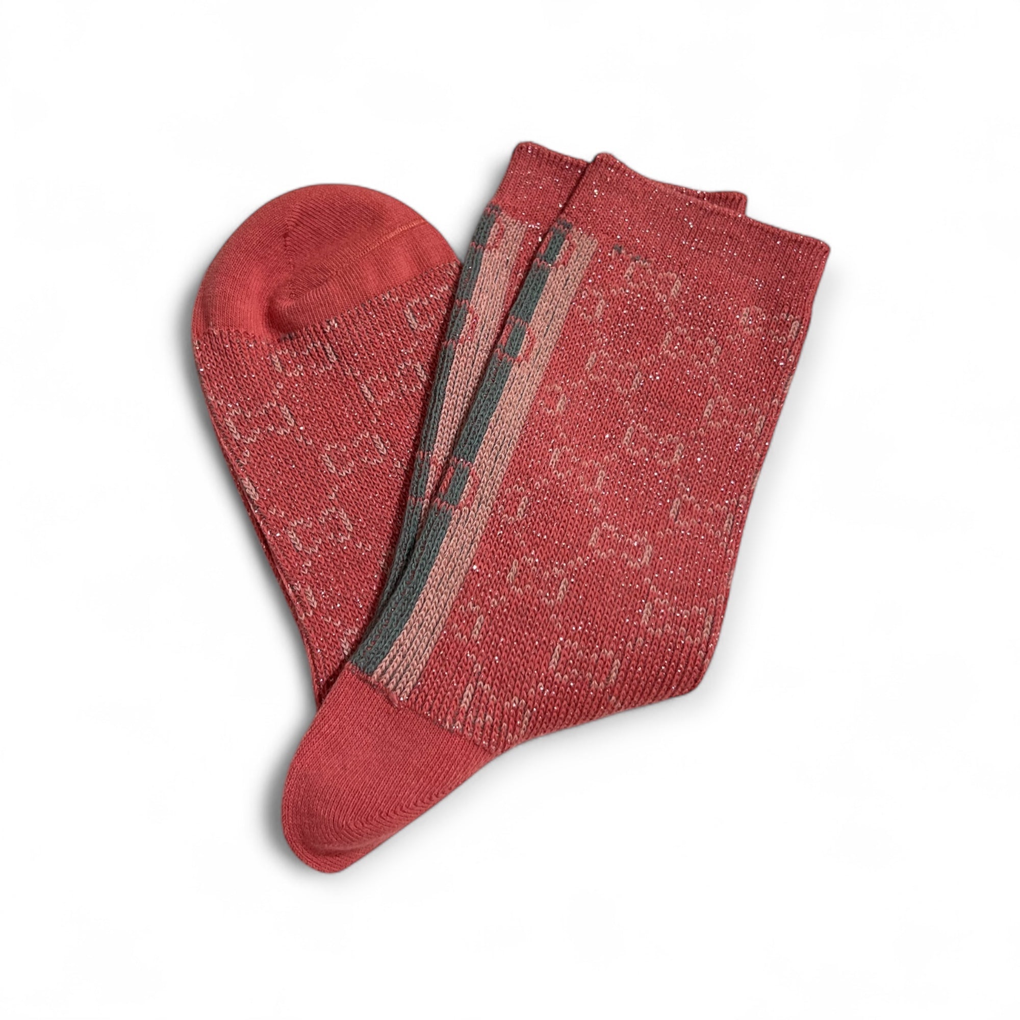 Rosa Strümpfe mit eingewebten Muster, feinen Glitzerfäden und seitlich Streifen in Grün und Rosa Töne. Flach liegend auf weißem Hintergrund.