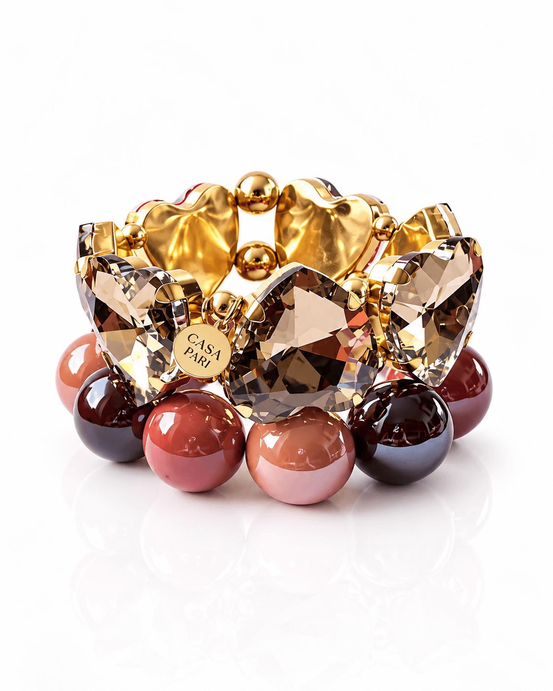 Crystal Heart × The Glossy Cinnamon Berry von CASA PARI mit großem champagnerfarbenem Kristallherz und glänzenden Resin-Perlen in Rosé-, Zimt- und Beerentönen.