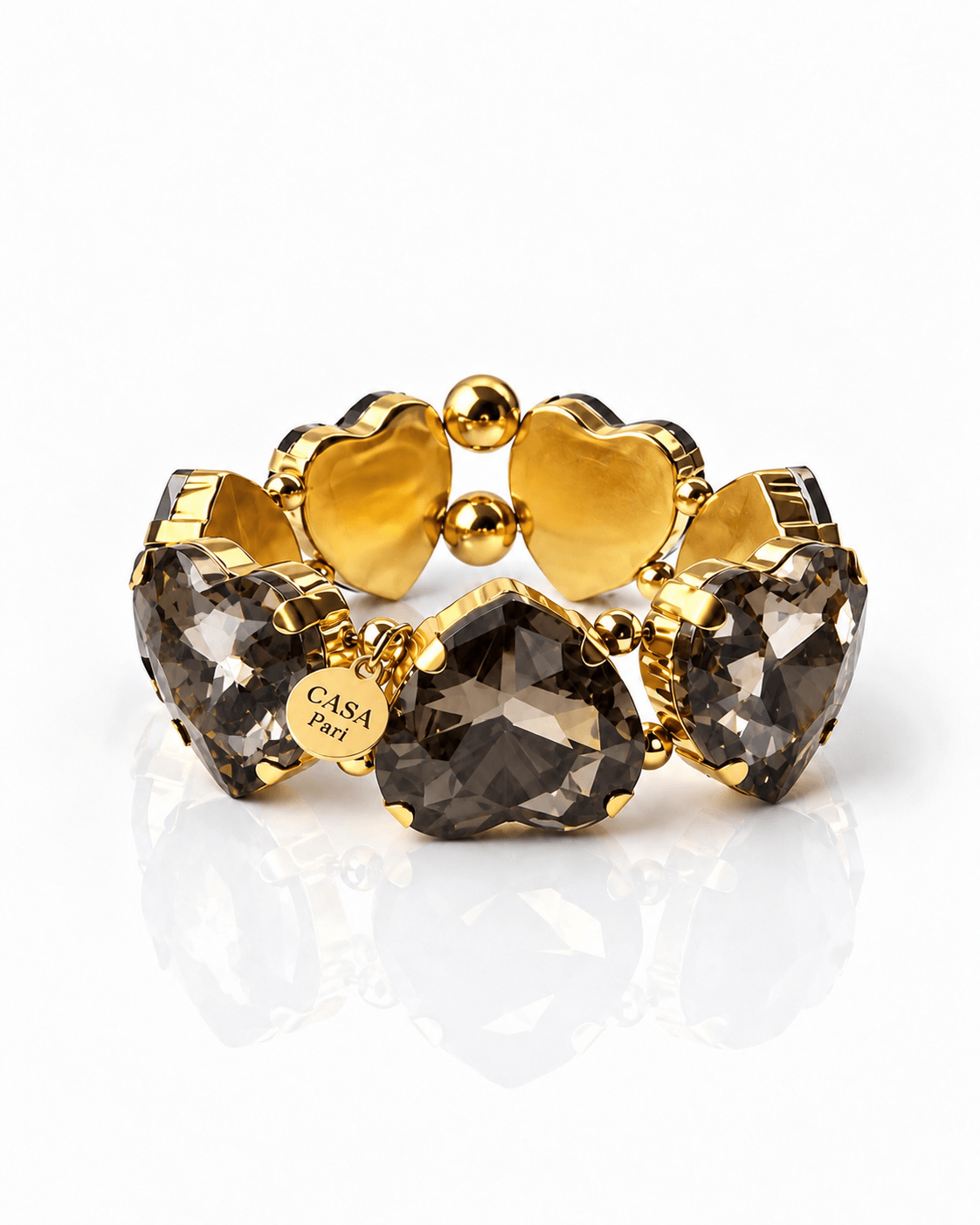 Crystal Heart Armband mit großen facettierten Herzsteinen in Smoky Grey und goldfarbenen Details von Casapari.