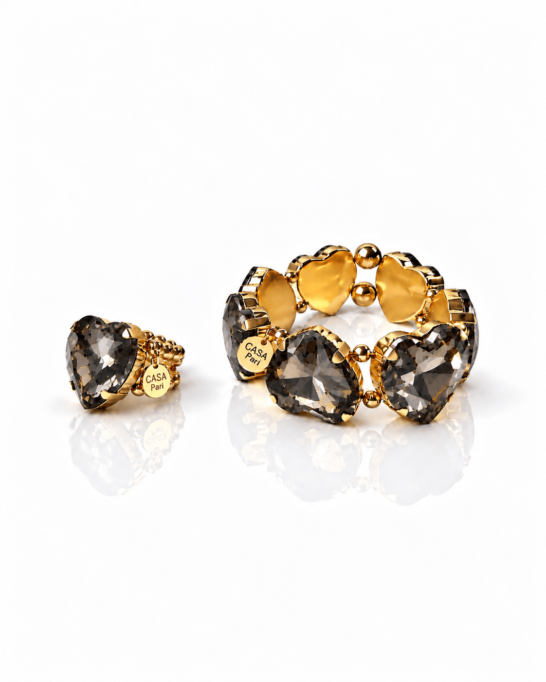 Crystal Heart Set mit Ring und Armband, facettierten rauchgrauen Herzen und goldfarbenen Edelstahl-Details von Casapari.