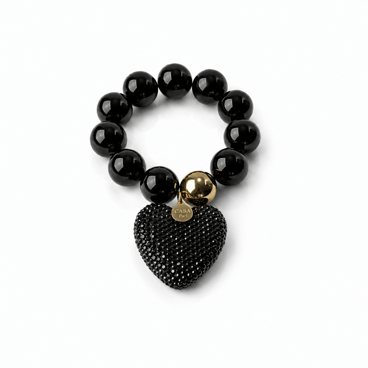 Schwarzes elastisches Statement-Armband mit glänzenden 20-mm-Resin-Perlen, großem schwarzen Strassherz und goldfarbenen Details.