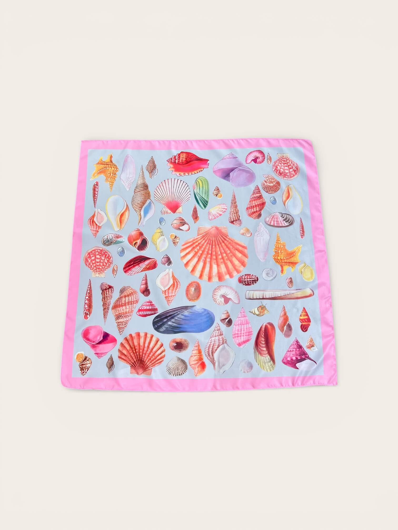 Schal auf im Hintergrund fotografiert. Der Schal ist in rosa bunt gehalten. Mit Seestern darauf im maritim Design.