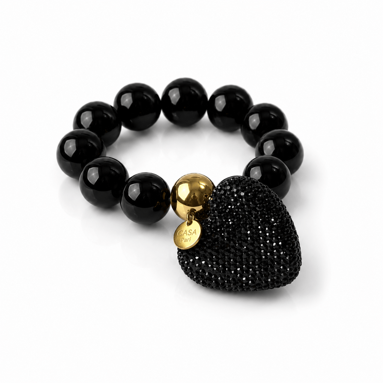 Schwarzes elastisches Statement-Armband mit glänzenden 20-mm-Resin-Perlen, großem schwarzen Strassherz und goldfarbenen Details.