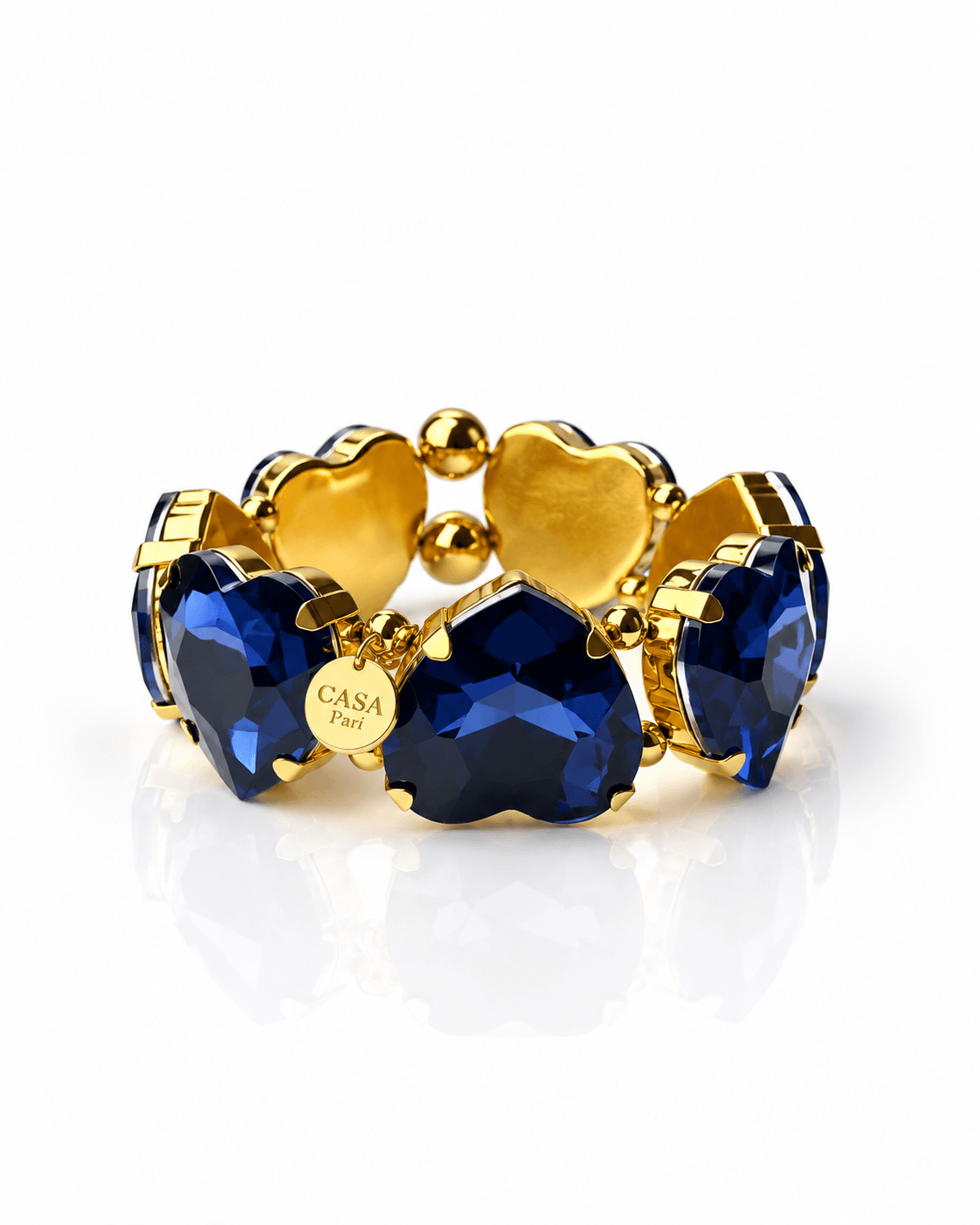 Crystal Heart Armband mit großen facettierten Herzsteinen in tiefem Blau und goldfarbenen Details von Casapari