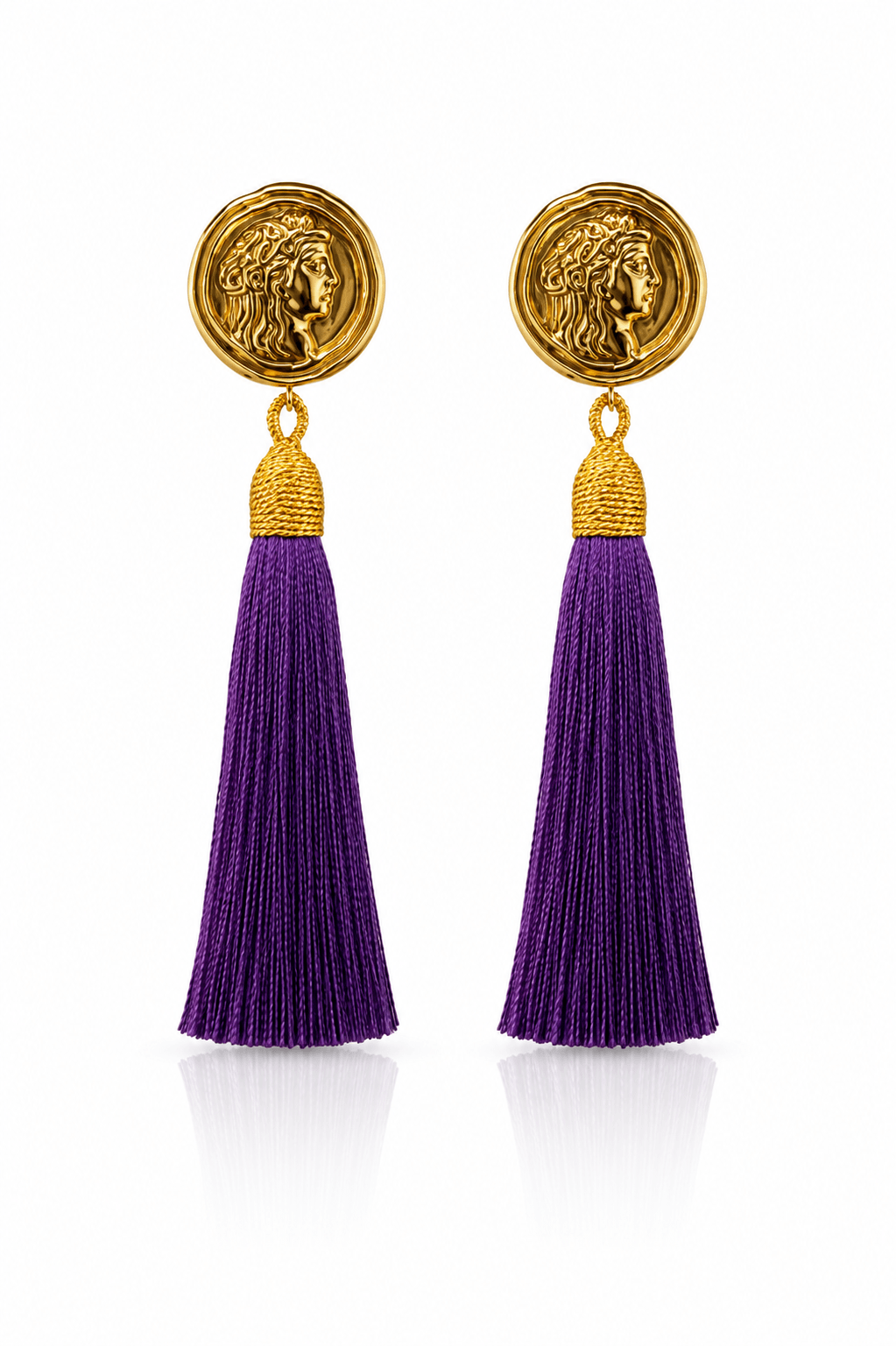 Goldfarbene Statement-Ohrringe mit römisch inspirierter Münze und langen violetten Tasseln.